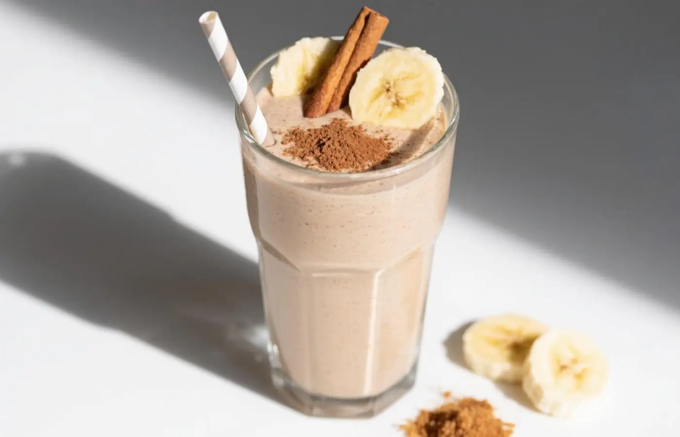A realistic photograph of a creamy peanut butter banana smoothie in a clear glass, topped with a sprinkle of chia seeds, high resolution. A realistic photograph of a creamy peanut butter banana smoothie in a clear glass, topped with a sprinkle of chia seeds, high resolution.