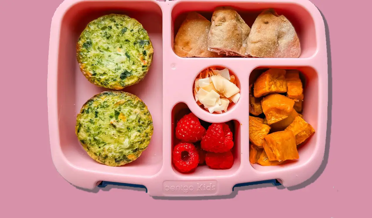 A lunchbox with Veggies Made Great egg white frittatas, raspberries, coconut flakes, roasted sweet potatoes and Ozery Bakery Morning Rounds. A lunchbox with Veggies Made Great egg white frittatas, raspberries, coconut flakes, roasted sweet potatoes and Ozery Bakery Morning Rounds.