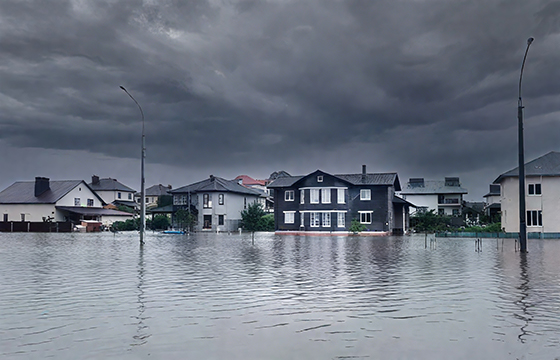Villages flooded under stormy skies, severe disaster scene.