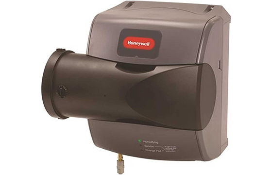 A gray Honeywell whole - house humidifier, wall - mounted, with visible control indicators and a connection pipe at the bottom