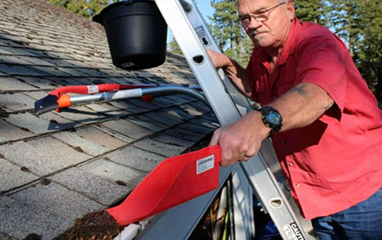 A person cleaning the gutter